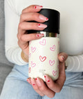 IRISgo Thermobecher mit Herz-Design in der Hand gehalten – stylischer, personalisierbarer Becher als Geschenkidee